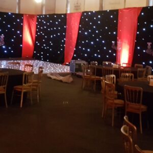 venue transformation with starcloth and red velvet drape